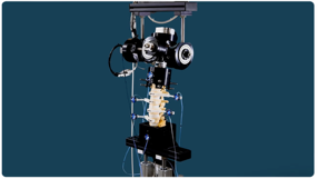 Detail view of the six degrees of freedom simulator loading head above a mounted spinal specimen